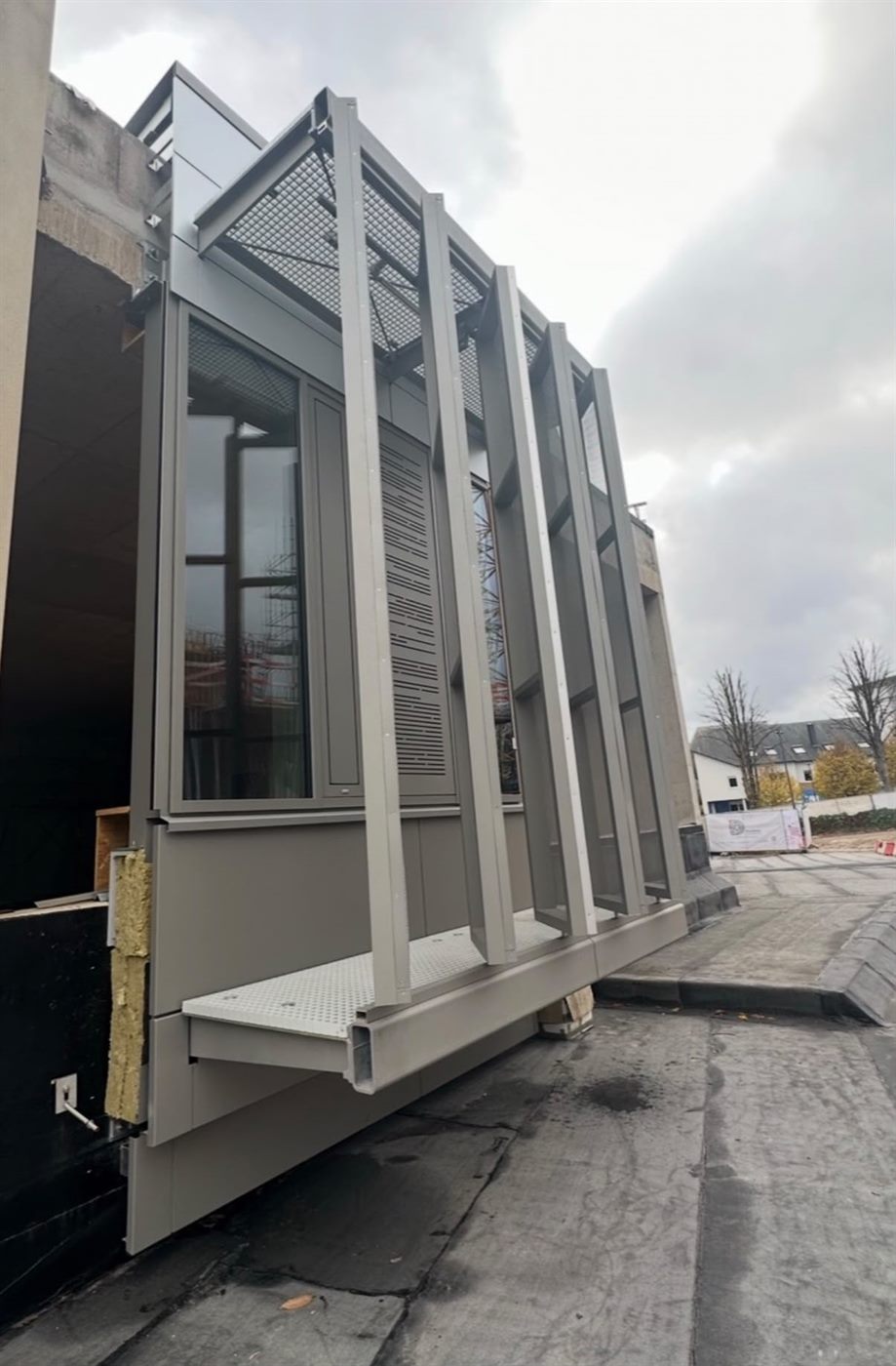 Completed façade section with vertical fins and walkway