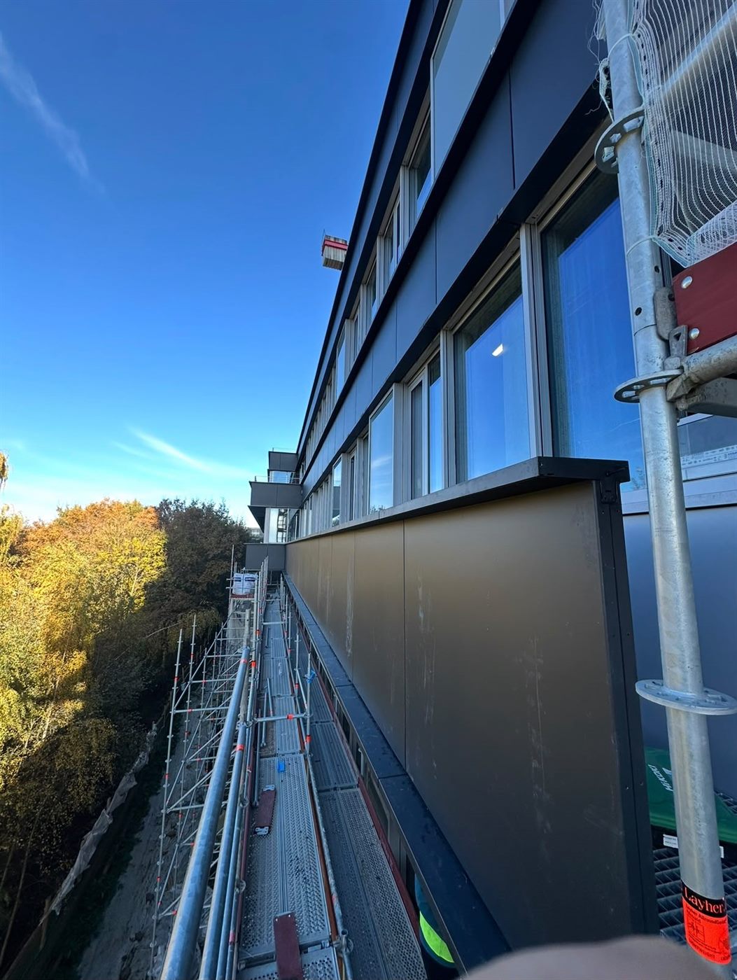 Finished façade elevation with glazing and rainscreen